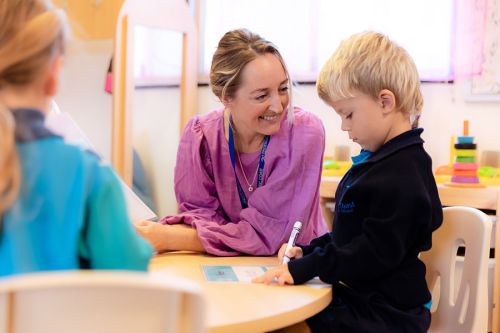 Prep teacher helping student with writing